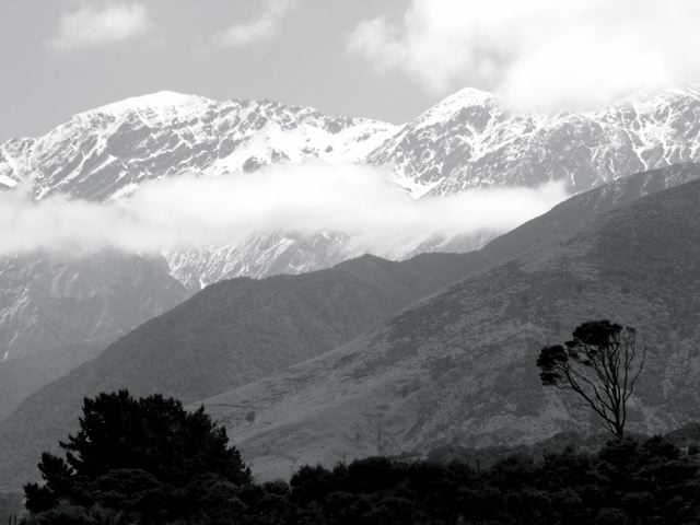 Seaward Kaikoura Ranges in black and white with snow-capped peaks and cloud