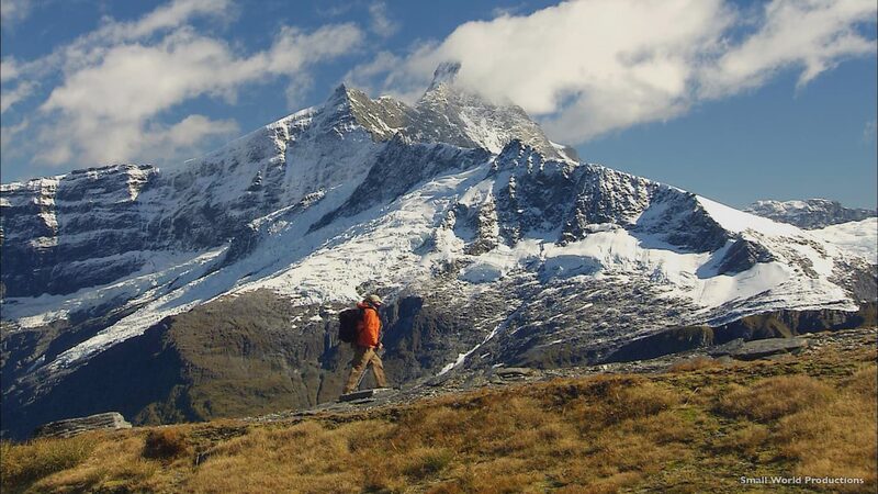 Hiker Mount Aspiring Wanaka North Island vs South Island New Zealand